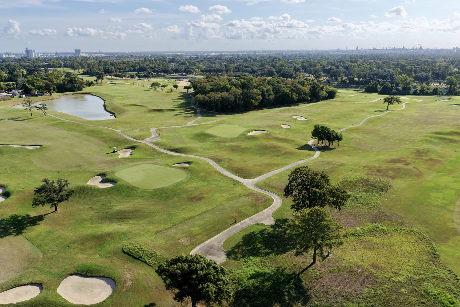 Golf course fairways with the Houston skyline on the horizon